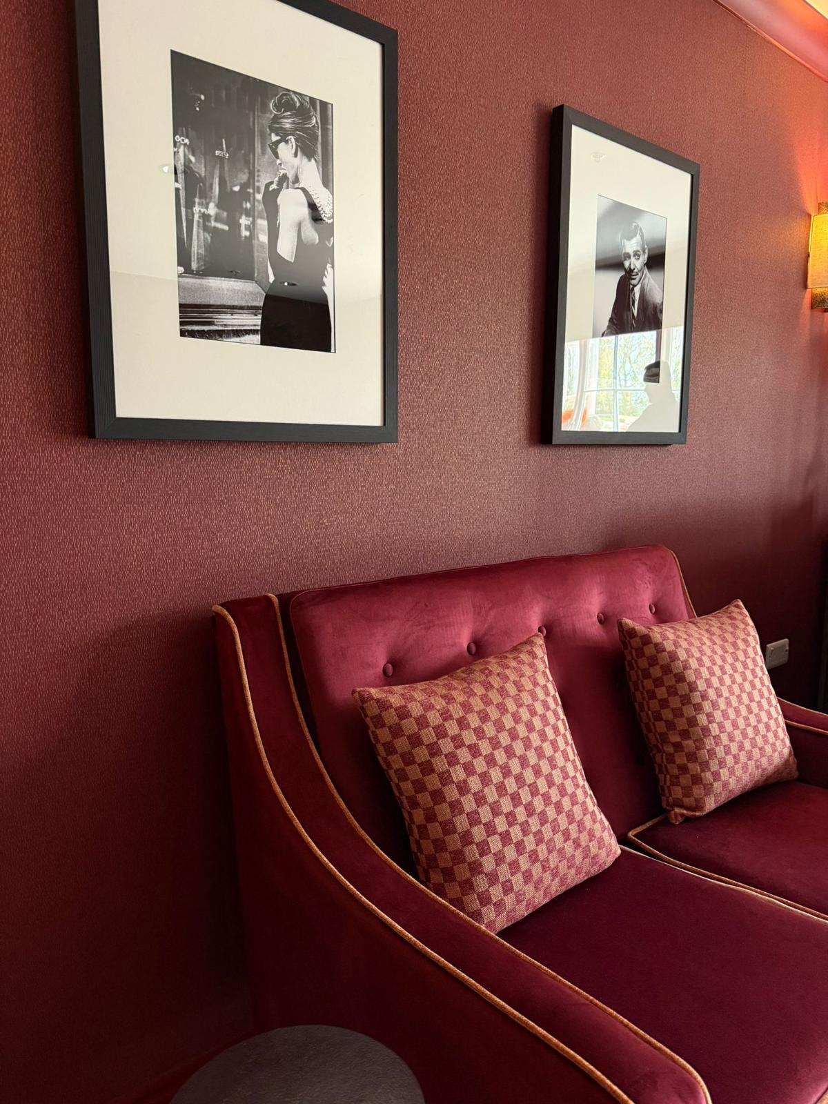 Cosy snug with vintage cinema photographs at Oadby Manor